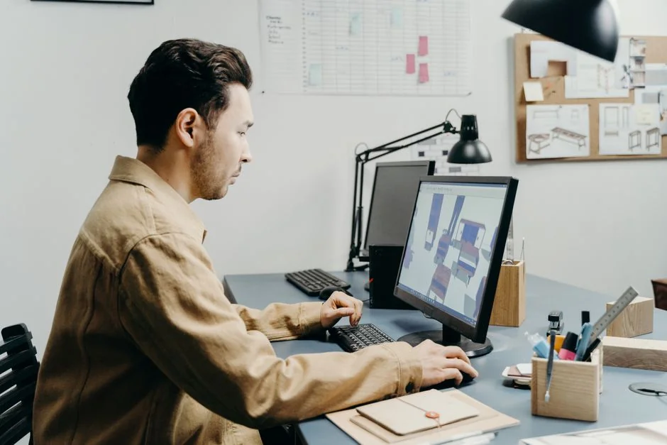 A modern workspace featuring dual computer monitors displaying web design projects, emphasizing technology and productivity.